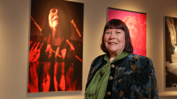Bronagh Hinds, DemocraShe and Women’s Coalition standing in front of her portrait which features in the 'Principled & Revolutionary: Northern Ireland’s Peace Women' exhibition at Ulster Museum to mark the 25th anniversary of the Belfast/Good Friday Agreement.