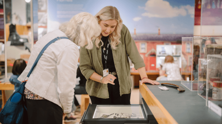Two women looking at objects in Discover History
